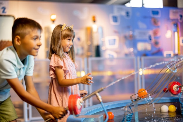 Little boy and girl playing in a science museum