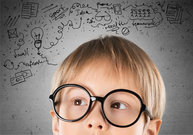 Little boy in glasses on sketch background