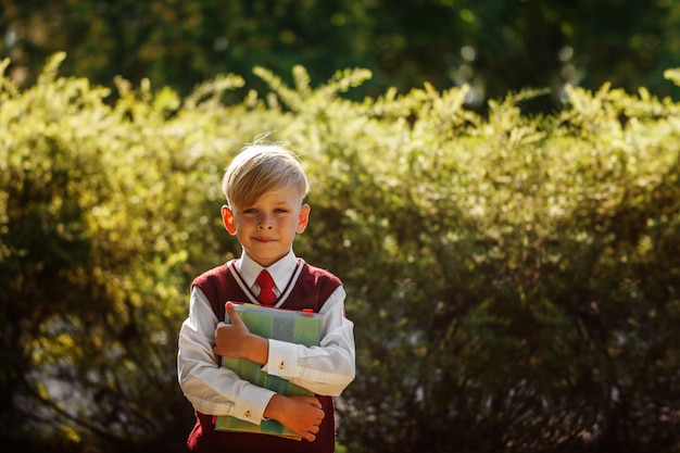 Little boy going back to school. Child with backpack and books on first school day