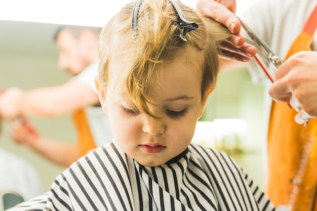 Little boy in a hairdressing salon