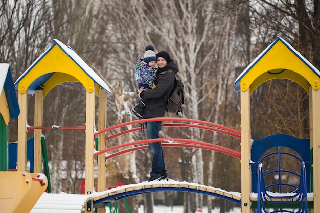 The little boy in the hands of his father in the winter weather Walk in the Park in the snow