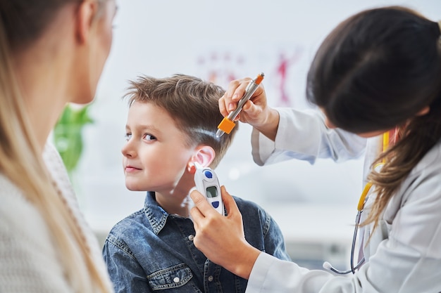 little boy having medical examination by pediatrician