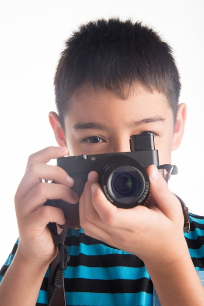 Little boy holding camera