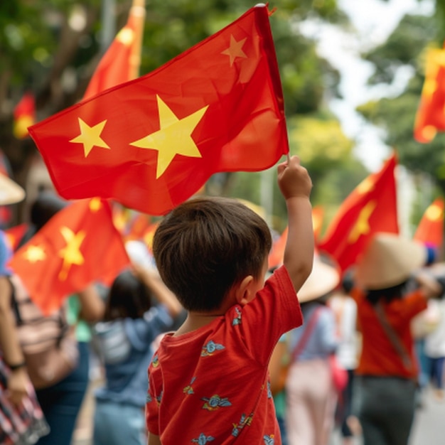 a little boy holding a red flag with yellow stars on it