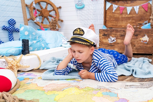 little boy in the image of a sailor playing in his room.