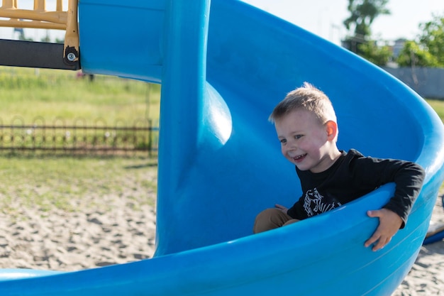 A little boy is riding a children's hill Rest the child on the playground