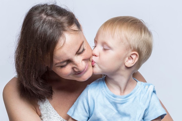 Little boy kisses his mother The family hugs and kisses Love and tenderness Closeup