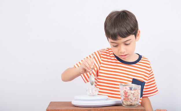 Little boy leaning weight scale education in class