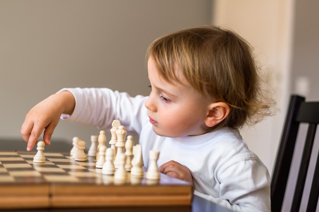 Little  boy learn to play chess.