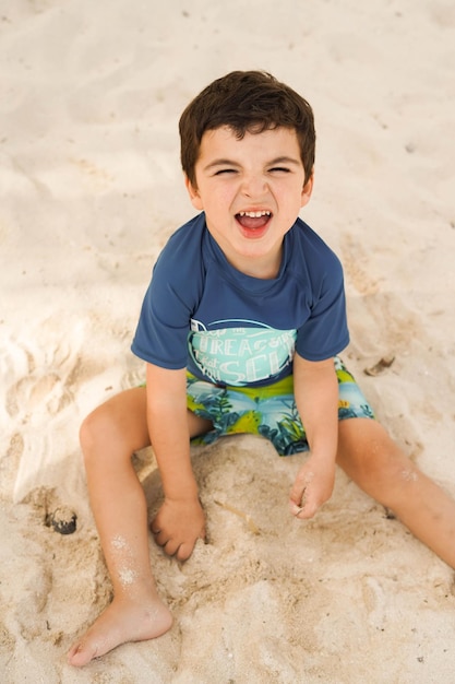 Little boy playing in the sand on the beach