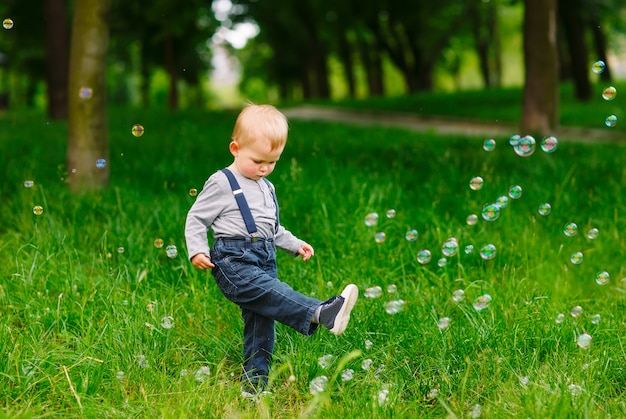 Little boy playing with soap bubbles.