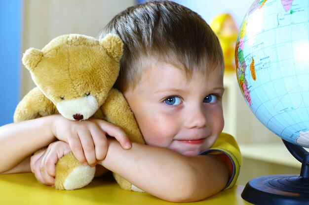 Little boy plays with a teddy bear