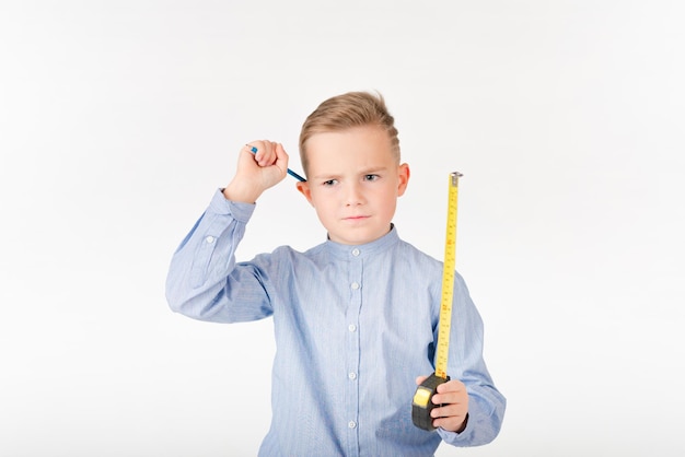 Little boy stretches roulette and pencil something is thinking Childhood education