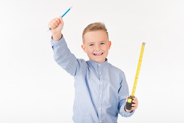 Little boy stretches roulette and pencil something is thinking Childhood education