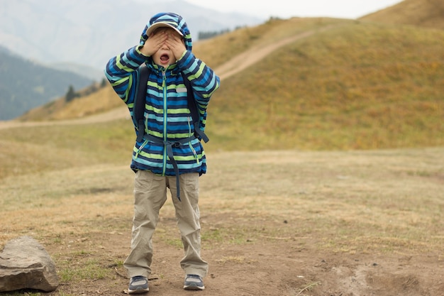 Little boy and travel in mountains, family hiking in nature