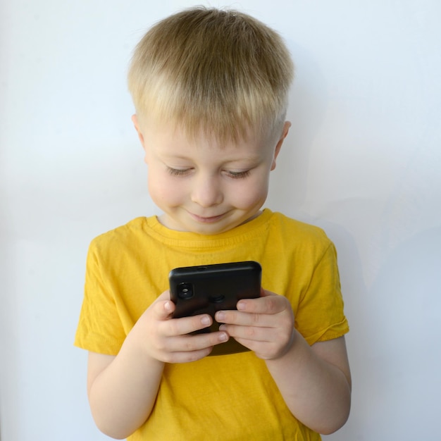 little boy uses a smart phone