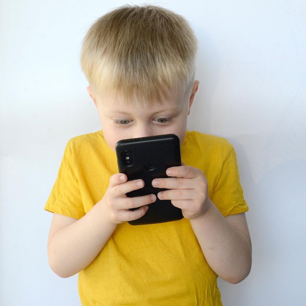 little boy uses a smart phone