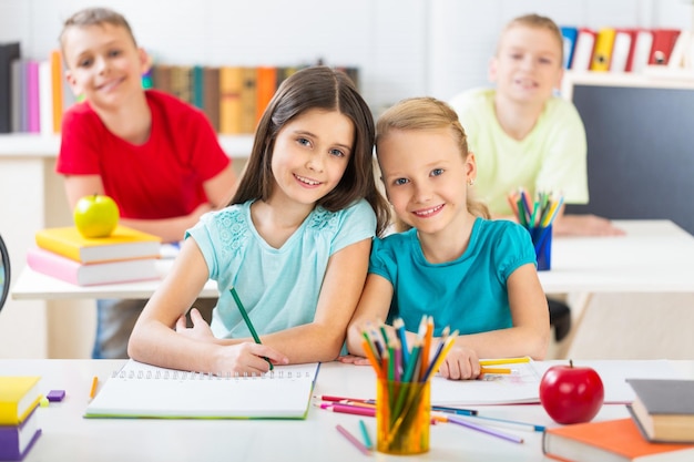 Little boy using digital tablet at desk in classroom