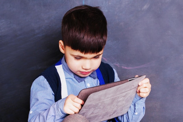 Little boy using tablet at home