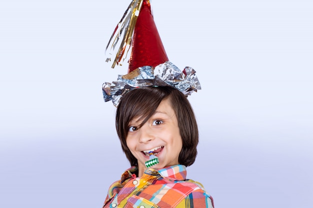 Little boy wearing a party hat.