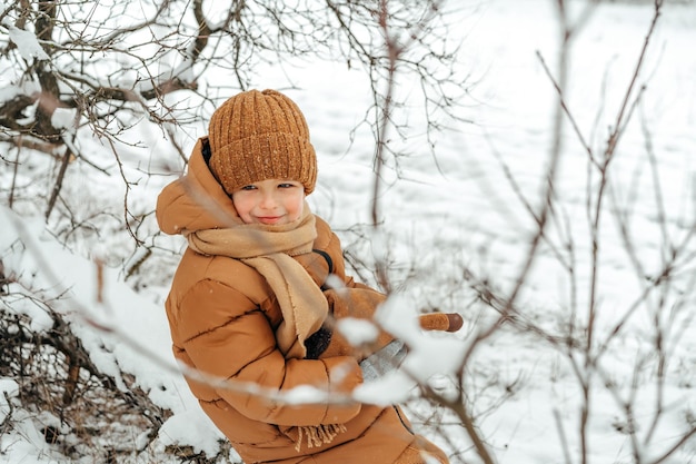 Little boy in a winter park or forest