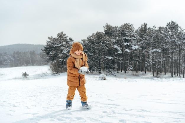 Little boy in a winter park or forest