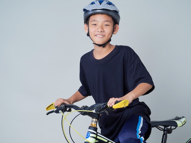 Little boy with bicycle on light background