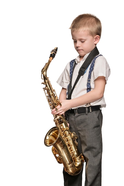 Photo little boy with big golden saxophone in his hands isolated on white background