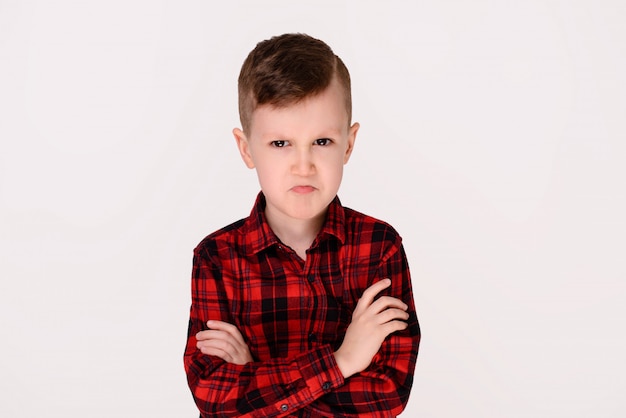 The little boy with expressive emotion on a white background. 