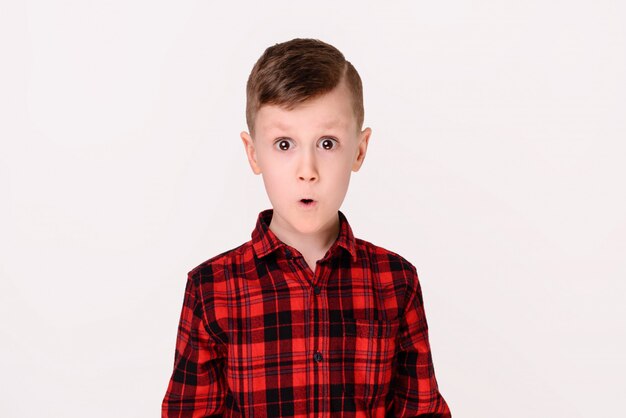 The little boy with expressive emotion on a white background. 