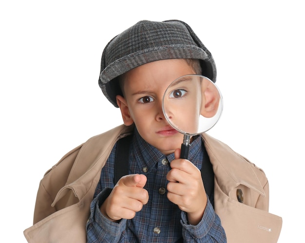 Little boy with magnifying glass playing detective on white background