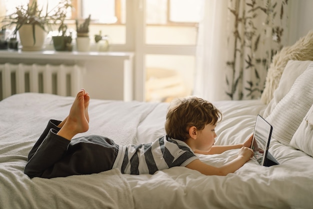 Little Boy with a tablet in the room