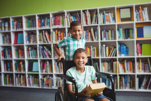 Little boys holding books