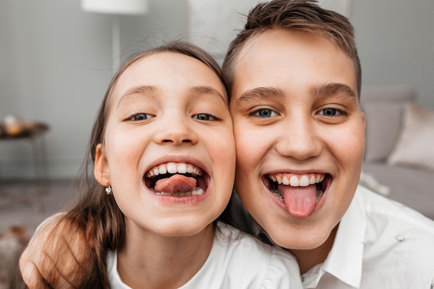 Little brother and sister making funny faces