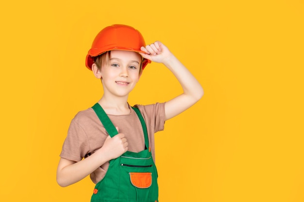 Little builder in helmet. Child dressed as a workman builder. Little boy wearing helmet. Portrait little builder in hardhats. Child building helmet, hard hat.