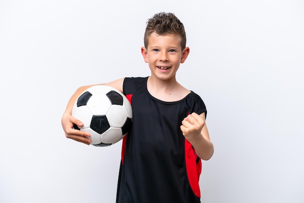 Little caucasian boy isolated on white background with soccer ball celebrating a victory