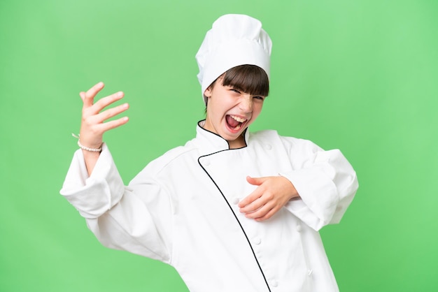 Little caucasian chef girl over isolated background making guitar gesture