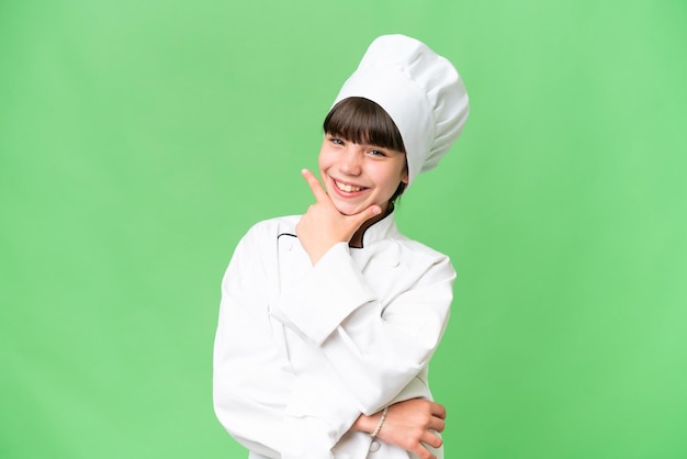 Little caucasian chef girl over isolated background smiling