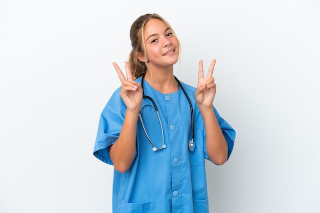 Little caucasian girl disguised as surgeon isolated on white background showing victory sign with both hands