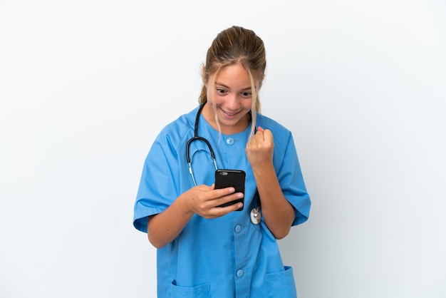 Little caucasian girl disguised as surgeon isolated on white background surprised and sending a message