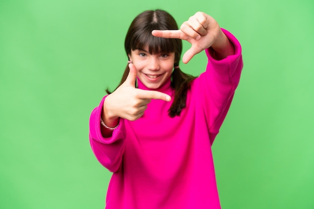 Little caucasian girl over isolated background focusing face Framing symbol