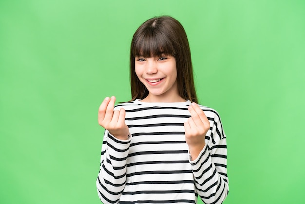 Little caucasian girl over isolated background making money gesture