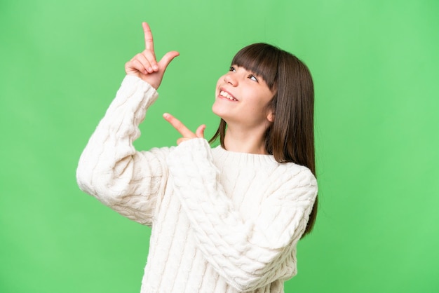 Little caucasian girl over isolated background pointing with the index finger a great idea