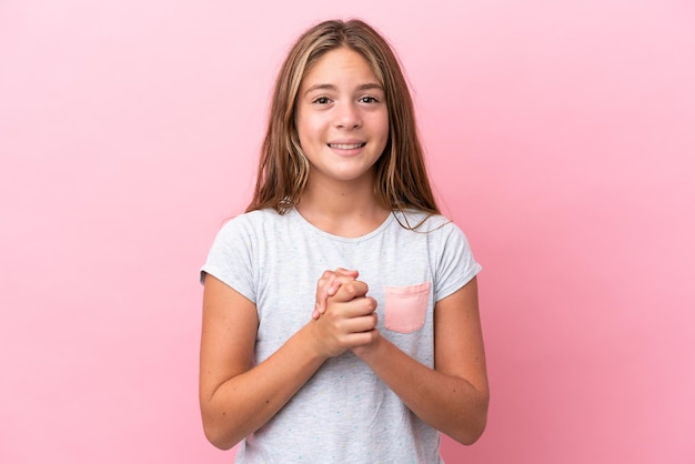 Little caucasian girl isolated on pink background laughing