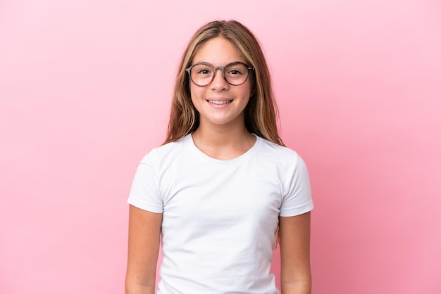 Little caucasian girl isolated on pink background With glasses with happy expression