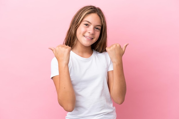 Little caucasian girl isolated on pink background with thumbs up gesture and smiling