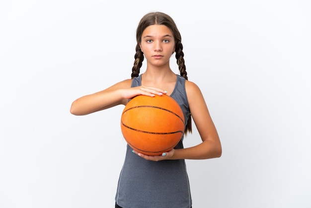 Little caucasian girl isolated on white background playing basketball