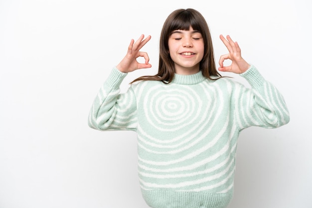 Little caucasian girl isolated on white background in zen pose