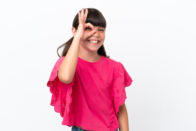 Little caucasian kid isolated on white background showing ok sign with fingers