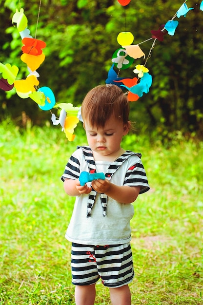 Little cheerful boy playing in the park, playground, laughing. spring walk. sunny day. Family, kids